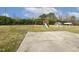 Large backyard featuring a swing set and playhouse on a concrete patio at 55 Oak Leaf Dr, Lillington, NC 27546