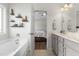 Bright bathroom with bathtub, double vanity, and view to ensuite bedroom at 55 Oak Leaf Dr, Lillington, NC 27546