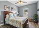 Well-lit bedroom with ceiling fan, side tables, and a plant in the corner at 55 Oak Leaf Dr, Lillington, NC 27546