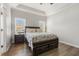 Spacious primary bedroom featuring wood floors, large window, and bedside tables at 55 Oak Leaf Dr, Lillington, NC 27546