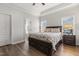 A cozy bedroom features wood floors, tray ceiling, and bedside tables at 55 Oak Leaf Dr, Lillington, NC 27546