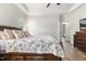 Comfortable primary bedroom with wood floors and view to ensuite bathroom at 55 Oak Leaf Dr, Lillington, NC 27546