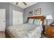 Cozy bedroom features a wooden bed frame, nautical artwork, and soothing blue wall color at 55 Oak Leaf Dr, Lillington, NC 27546