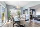 Open dining area with a view of the fireplace, chandelier, and ample natural light at 55 Oak Leaf Dr, Lillington, NC 27546