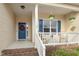 Welcoming front porch with classic columns, hanging plants, and comfortable seating at 55 Oak Leaf Dr, Lillington, NC 27546