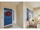 Inviting front porch with blue door and colorful wreath, offering a welcoming entrance at 55 Oak Leaf Dr, Lillington, NC 27546