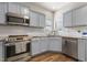 Modern kitchen with stainless steel appliances and tiled backsplash at 55 Oak Leaf Dr, Lillington, NC 27546