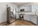 Well-equipped kitchen with stainless steel appliances, light-blue cabinets, and granite countertops at 55 Oak Leaf Dr, Lillington, NC 27546