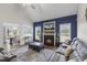 Cozy living room with fireplace and large sectional couch with view to dining area at 55 Oak Leaf Dr, Lillington, NC 27546