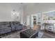 Open-concept living room featuring a gray leather sofa set, dark wood floors, and light blue walls at 55 Oak Leaf Dr, Lillington, NC 27546