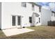 Backyard featuring a patio, white siding, and grass with a wooded fence, providing outdoor space at 5526 Spindlewood Ct, Durham, NC 27703
