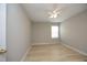 Bedroom with a neutral color scheme, hardwood floors, and a large window, creating a cozy atmosphere at 5526 Spindlewood Ct, Durham, NC 27703