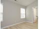 Bright bedroom with two windows, hardwood floors, and neutral paint, providing a serene space at 5526 Spindlewood Ct, Durham, NC 27703