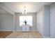 A dining room with hardwood floors, a pendant light, and a table with a plant at 5526 Spindlewood Ct, Durham, NC 27703