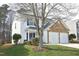 Two-story home featuring a stone garage facade and manicured lawn at 5526 Spindlewood Ct, Durham, NC 27703