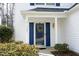 Close-up of a home's bright blue front door with decorative wreath and sidelights at 5526 Spindlewood Ct, Durham, NC 27703