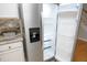 Stainless steel refrigerator with granite countertops and stylish plants at 5526 Spindlewood Ct, Durham, NC 27703