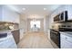 Bright kitchen featuring stainless steel appliances and a breakfast area with natural light at 5526 Spindlewood Ct, Durham, NC 27703