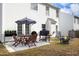 Backyard patio area with an outdoor dining set, umbrella, grill, and fire pit at 5526 Spindlewood Ct, Durham, NC 27703