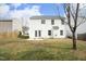 Exterior rear view featuring a large yard, white siding, and access to the patio at 5526 Spindlewood Ct, Durham, NC 27703