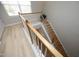 Bright staircase with hardwood steps, white banister, and natural light from the window at 5526 Spindlewood Ct, Durham, NC 27703