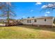 Expansive backyard with a charming deck and a beautiful, well-maintained lawn at 5636 Thom Rd, Mebane, NC 27302