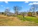 Spacious backyard with a wooden shed, mature trees, and ample space for outdoor activities at 5636 Thom Rd, Mebane, NC 27302