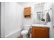 Standard bathroom featuring a shower and tub, toilet, sink, and storage cabinet at 5636 Thom Rd, Mebane, NC 27302