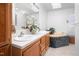 Bathroom featuring double sinks, granite countertops, and bathtub with jets, providing a luxurious feel at 5636 Thom Rd, Mebane, NC 27302