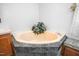 Bathroom featuring a corner bathtub, and tiled surround, offering a spa-like retreat at 5636 Thom Rd, Mebane, NC 27302