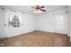 Bedroom featuring hardwood floors, neutral walls, a ceiling fan, and natural light from two windows at 5636 Thom Rd, Mebane, NC 27302