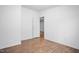 Empty bedroom with hardwood floors, neutral paint, and natural light from the window at 5636 Thom Rd, Mebane, NC 27302
