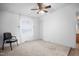 Bedroom features a ceiling fan, carpeted floor, and natural light from the window at 5636 Thom Rd, Mebane, NC 27302