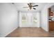 Bright dining area with hardwood floors, ceiling fan, and large windows providing a view of the outdoors at 5636 Thom Rd, Mebane, NC 27302