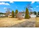 Exterior view of a charming single-story home with a detached garage and well-kept yard at 5636 Thom Rd, Mebane, NC 27302
