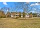 Lovely single-story home with a spacious front yard and mature trees, creating a serene setting at 5636 Thom Rd, Mebane, NC 27302