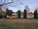 Inviting home showcasing a front porch, lush lawn, and symmetrical landscaping at 5636 Thom Rd, Mebane, NC 27302