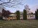 Inviting home showcasing a front porch, lush lawn, and symmetrical landscaping at 5636 Thom Rd, Mebane, NC 27302