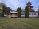 Charming home featuring a cozy porch, manicured lawn, and mature trees at 5636 Thom Rd, Mebane, NC 27302