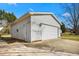 Detached two car garage has white door and siding, with a convenient side door at 5636 Thom Rd, Mebane, NC 27302