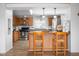 Open concept kitchen with stainless steel appliances, a breakfast bar, hardwood floors, and plenty of cabinets at 5636 Thom Rd, Mebane, NC 27302