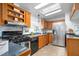 This kitchen offers stainless steel appliances, wood cabinets, tiled backsplash and hardwood floors at 5636 Thom Rd, Mebane, NC 27302