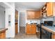Kitchen features wood cabinets, tiled backsplash, tile flooring, and modern appliances at 5636 Thom Rd, Mebane, NC 27302