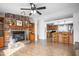 Open concept living room flows into the kitchen with a stone fireplace and breakfast bar at 5636 Thom Rd, Mebane, NC 27302