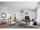 Bright living room featuring a fireplace, modern furniture, and an open layout to the dining area at 5636 Thom Rd, Mebane, NC 27302
