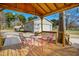 Covered porch showcasing a view of the shed in the backyard and outdoor seating at 5636 Thom Rd, Mebane, NC 27302