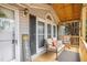 Charming front porch featuring comfortable seating and views of the surrounding landscape at 5636 Thom Rd, Mebane, NC 27302