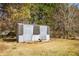 Rustic shed exterior with weathered wood and double doors in a grassy backyard at 5636 Thom Rd, Mebane, NC 27302
