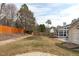 Spacious backyard with a fire pit area, shed, and screened-in porch at 5812 Solitude Way, Durham, NC 27713