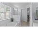 Bright bathroom features a tub with tile surround and built-in shelving at 5812 Solitude Way, Durham, NC 27713